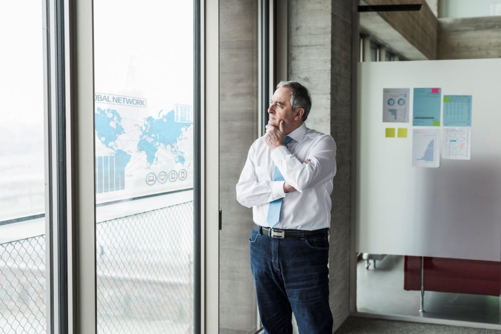 businessman-looking-at-windowpane